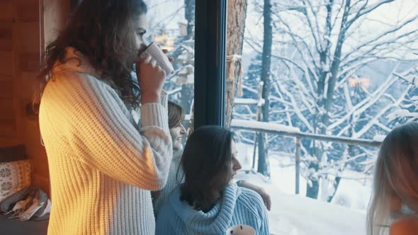 Happy Young Women Celebrating New Year in Wooden Mountain Hut