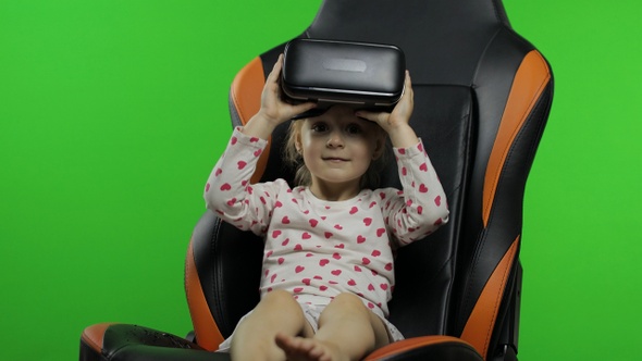 Child Girl Using VR Headset Helmet To Play Game. Watching Virtual Reality 3d 360 Video. Chroma Key