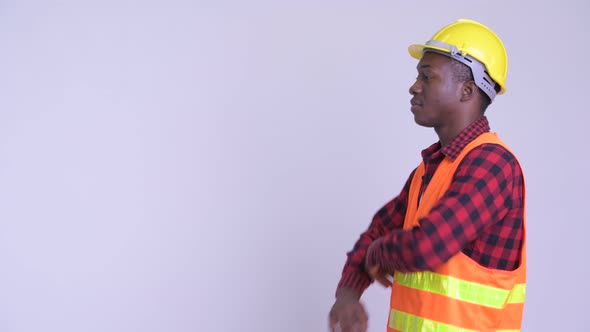 Profile View of Happy Young African Man Construction Worker with Arms Crossed