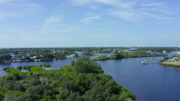 Slow Rising Aerial Pan of Waterfront Homes and Small Town Near a Bay