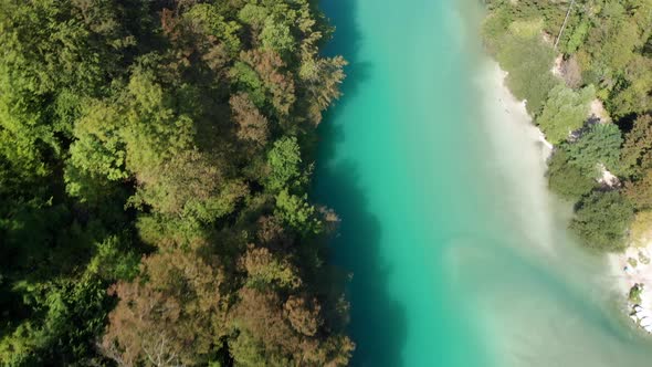 Aerial view of beautiful Soca river. Top down view of emerald river. Flying over river in Slovenia.