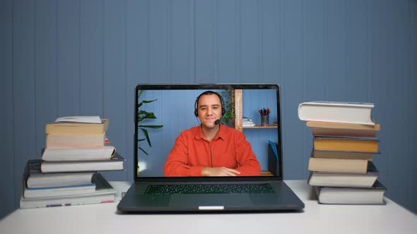 Young Man in Headset with Microphone Holding Online Meeting Conversation