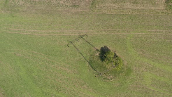 Shadow of electric power transmission system on the field 4K drone video