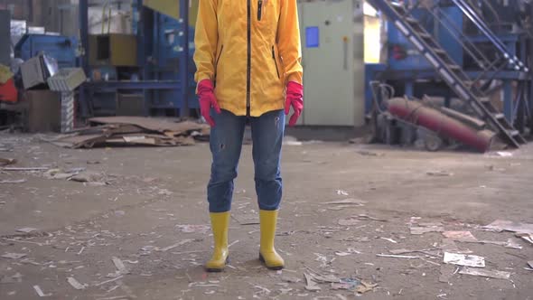 A Young Girl with Dreadlocks in Protective Working Clothes Yellow Jacket Eyeglasses Hard Hat and