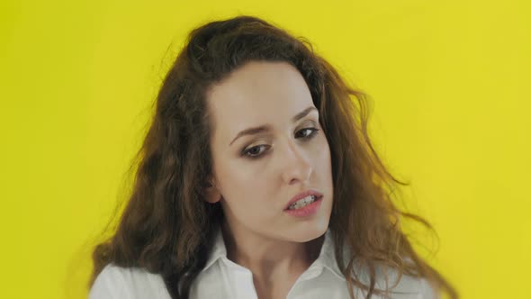 Portrait of Discontent Woman Expressing Aversion and Demonstrating Her Disgust in Studio with Yellow