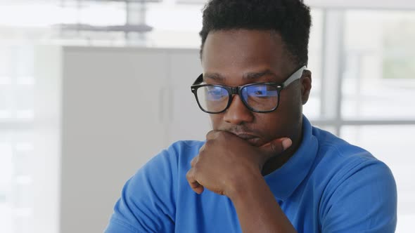 Close Up of African Male Entrepreneur Using Laptop Sitting at Desk in Office