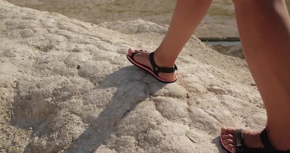 Closeup of Female Legs Walking on a Rock