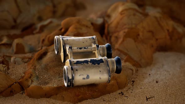 Old German Military Binoculars on the Sand Beach alt