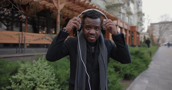 African Man Puts on Headphone in Slow Motion