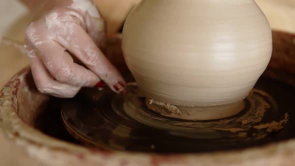 Front View of Female Hands Work with Clay on a Potter's Wheel