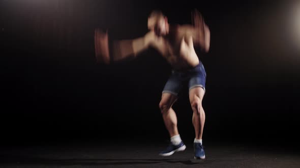 Young Pumped Man Trains His Body in the Arena  Warming Up