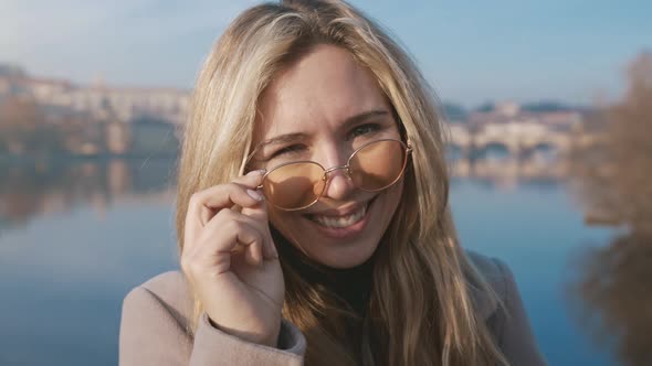 Closeup Portrait of a Happy Young Woman Smiling at the Camera