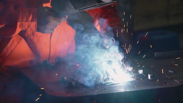 Metal welder working with arc welding machine