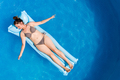 Young woman in bikini on Air Mat Mattress in round above ground swiming pool. Top view - PhotoDune Item for Sale