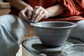 Hands of creative woman sculpture working with potter wheel during production of handmade utensils - PhotoDune Item for Sale