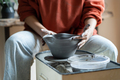 Ceramic master shaping bowl on pottery wheel in studio, creating pieces from clay - PhotoDune Item for Sale