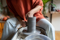 Close-up hand of woman handmade porcelain maker shaping vessel placed on rotating potter wheel - PhotoDune Item for Sale