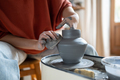Creating clay formed ceramic art vase or pot on potter wheel in workshop for home improvement store. - PhotoDune Item for Sale