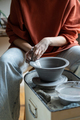 Ceramic master creating handmade stoneware on wheel in studio, forming clay into shape - PhotoDune Item for Sale