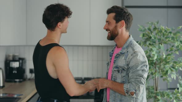 Gay Couple in Love at Home Dancing and Hugging Feeling Happy in Love Together