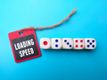 Dice and wooden board with the word LOADING SPEED. - PhotoDune Item for Sale
