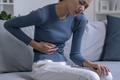 Woman suffering from strong abdominal pain - PhotoDune Item for Sale