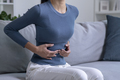 Woman suffering from strong abdominal pain - PhotoDune Item for Sale