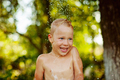  boy having fun, bathing and splashing in old iron bowl on the backyard  - PhotoDune Item for Sale