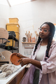 Woman washing her pottery at the ceramics studio - PhotoDune Item for Sale