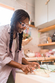 Woman with braided hair lighting up incense - PhotoDune Item for Sale