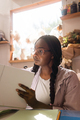 Woman with braided hair at her home office looking through the documents - PhotoDune Item for Sale