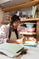 Woman with braided hair at her home office looking through the documents - PhotoDune Item for Sale