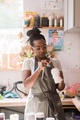 Woman taking paint out of the jar at ceramic studio - PhotoDune Item for Sale