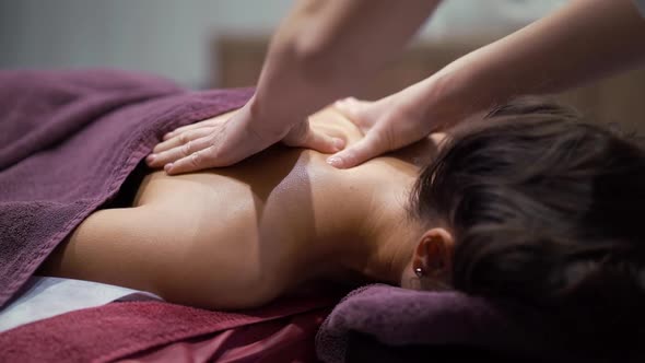 Woman Getting Upper Back Massage Wellness Spa