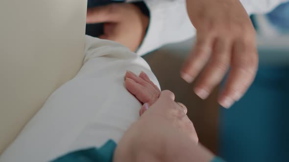 Vertical Video Male Doctor Comforting Senior Patient in Medical Cabinet