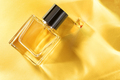 Transparent bottle of perfume on a yellow background with sun light rays. - PhotoDune Item for Sale