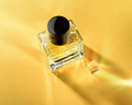 Transparent bottle of perfume on a yellow background with sun light rays. - PhotoDune Item for Sale