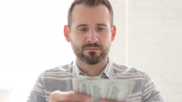 Adult Young Man Counting Dollar Paper Currency