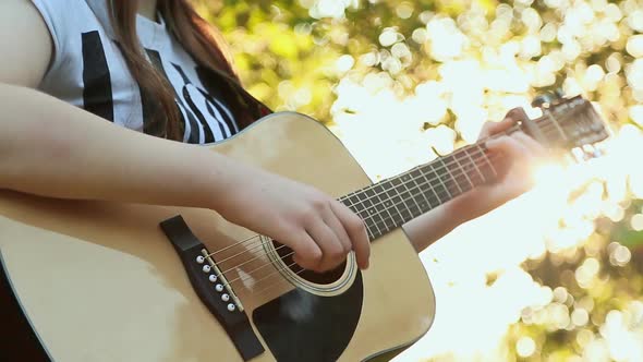 Girl's Hands Playing Acoustic Guitar Close Up