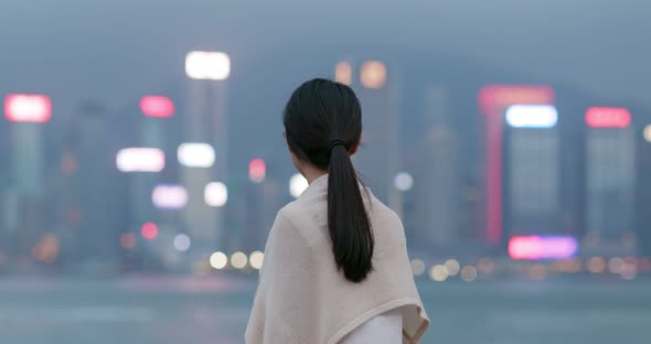 Woman enjoy the view of Hong Kong at night