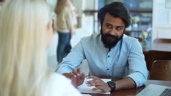 Closeup Back View of Female Applicant During Job Interview Talking to Young Male Employers