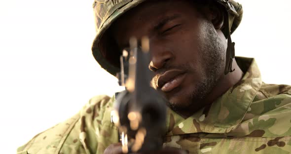 Portrait of military soldier aiming with machine gun