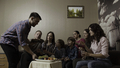Big happy family sitting on a couch by the small table with fruit plate. Stock. Celebration at home - PhotoDune Item for Sale
