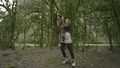 Woman takes pictures on camera in forest. Action. Woman with professional camera in green forest - PhotoDune Item for Sale