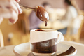 person dunking dripping spoon into cup of hot chocolate - PhotoDune Item for Sale