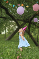 Funny Girl jumps up to hanging decorations in the park on her birthday. - PhotoDune Item for Sale