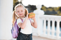 Happy pupil child girl eating burger at school - PhotoDune Item for Sale