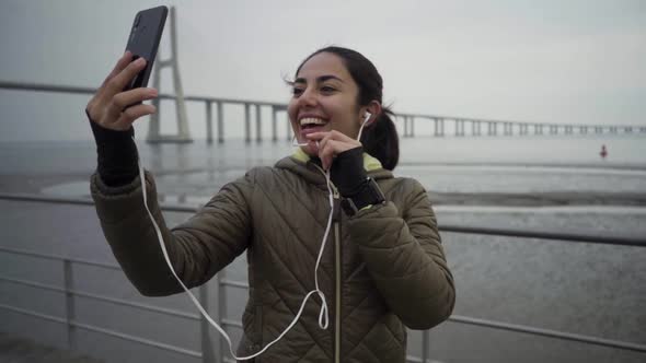 Smiling Hindu Woman Recording Video for Blog.