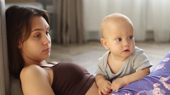 Young Brunette Mother Lying on Floor in Room Playing Together Baby Infant Child