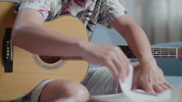 Man Composer With A Guitar Crumpled Paper Then Having A Headache While Composing Music At Home